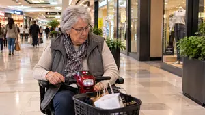 A Senior Shopper in the Mall Corridor 