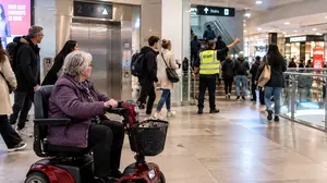 A Senior Rider on Her Mobility Scooter Exiting the Mall in an Emergency Alarm