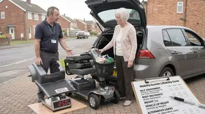 A Salesperson Showing a Senior Lady the Liftability of a Mobility Scooter