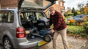 A Senior Rider Struggling to Fit His Scooter in the Car Boot